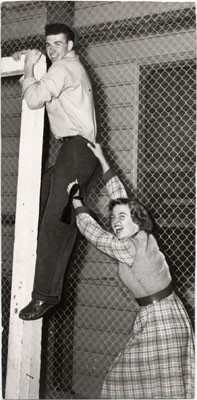 [Two students participating in "Sadie Hawkins Day" race at San Francisco State College]