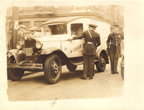 [Police officers inspecting motorist during strike of 1934]
