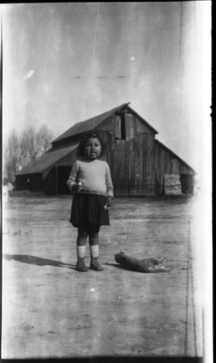 Gloria Pearl Roberts in front of barn with cat