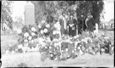 Four women standing at grave site of Lucy Hinds