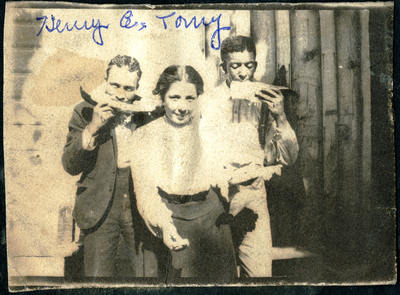 Two men and a woman eating watermelon