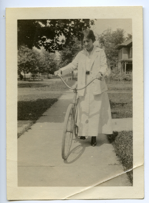 Pearl Mitchell standing on sidewalk with bicycle Wilburforce, Ohio