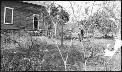 Pearl Roberts in front of farm house