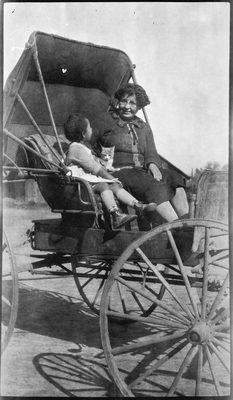 Pearl Roberts and Gloria Pearl Roberts riding in carriage with cat