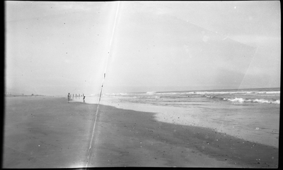 Woman and child fishing on beach