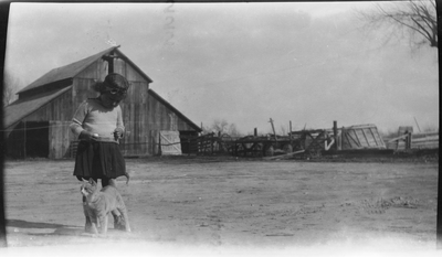 Gloria Pearl Roberts with cat in front of barn