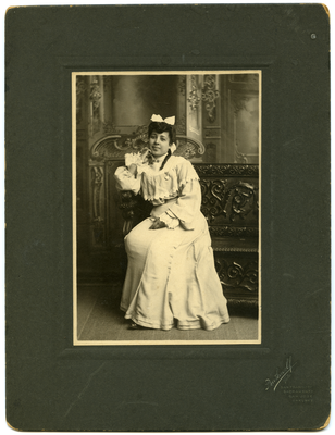 Portrait of Edith Hinds, age 19, sitting on bench