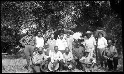 Group photograph of men and women in field