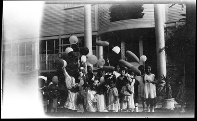 Children playing with balloons at party