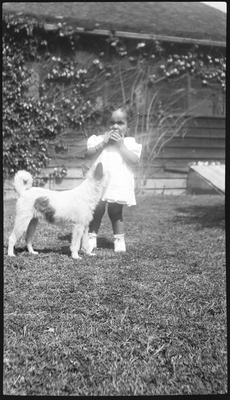 Patricia Roberts [?] with dog in yard