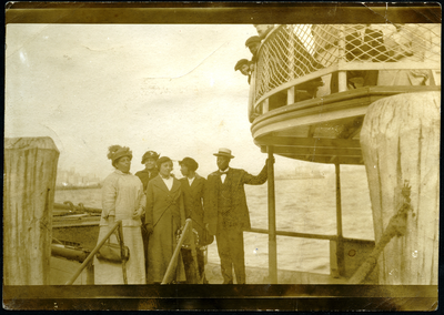 Five men and women standing on ferry deck