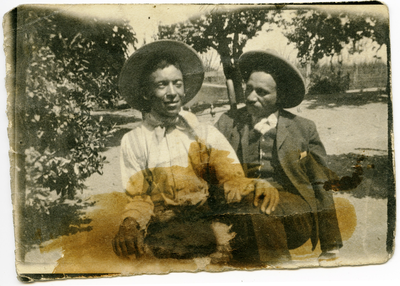 Two men sitting outside