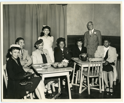Frederick M. Roberts (second from right) and his daughter Patricia Roberts (fourth from left) posing with group of men and women