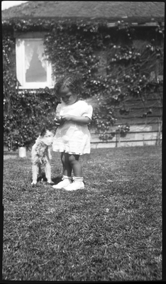 Patricia Roberts [?] with dog in yard