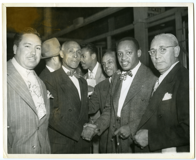 Lionel Hampton and Frederick M. Roberts shaking hands