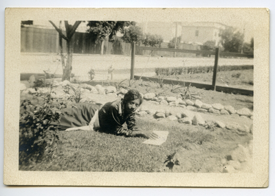 Elizabeth Armstrong lying in yard reading