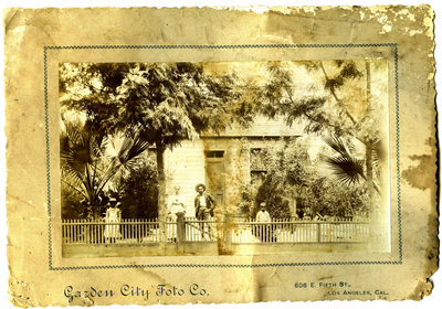 Myrtle Roberts, Ellen Wales Roberts, Frederick M. Roberts, and William Roberts standing in front of house Los Angeles, California