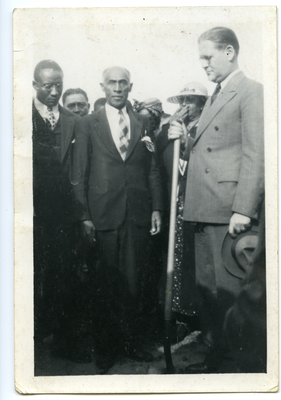 Frederick M. Roberts and Gordon McDonough standing in the front of crowd of people attending groundbreaking ceremony