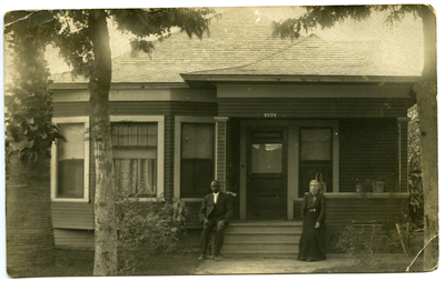 Man and woman sitting on front porch steps