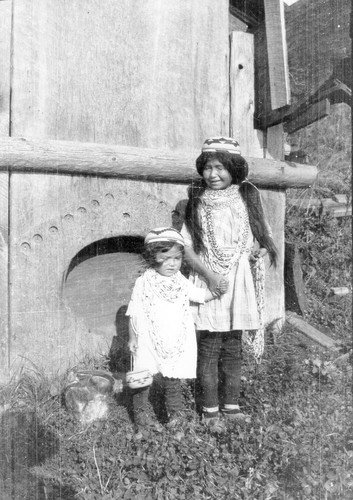 Requa: Small children in front of the doorway of the Brooks' house