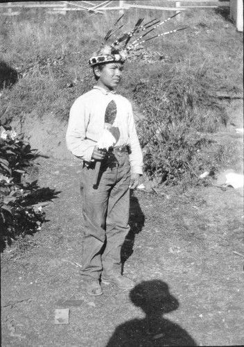 Man in a Brush Dance costume holding a dance knife