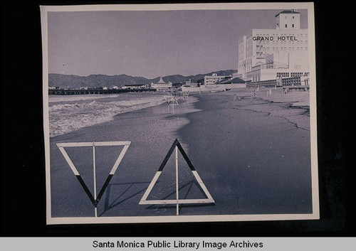 Tide studies from the Grand Hotel looking north to the Santa Monica Pier (markers pointing upwards are 1921 mean high tide line) with tide 3.6 feet at 10:06 AM on January 10, 1939