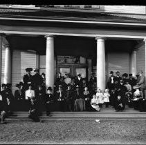 Group photograph of Fair Oaks families on the front porch of Fair Oaks Elementary School
