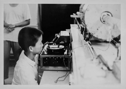 Chid looking at a Record Player