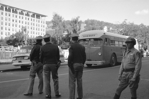 Alameda County sheriff's department bus and policemen on Bancroft Way