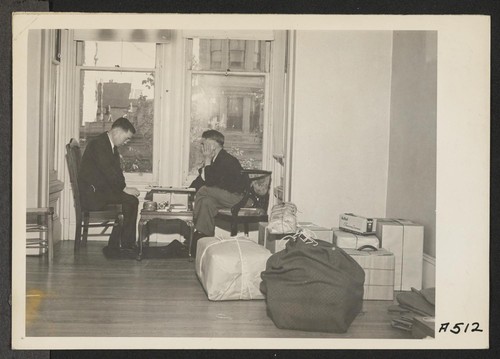 Two friends play final game while awaiting evacuation. Evacuees of Japanese descent are being housed in War Relocation Authority centers for the duration. Photographer: Lange, Dorothea San Francisco, California