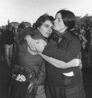 Two women hugging with a kiss on the forehead