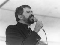 Reverend Troy Perry speaking into microphone