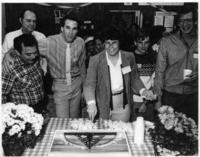 Liz Burkhouse cuts cake at celebration