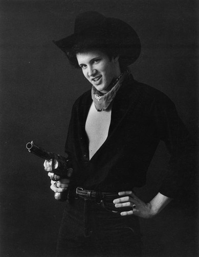 Man in western attire pointing gun