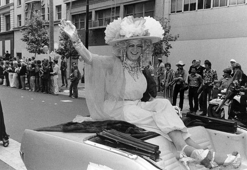 Female impersonator on a car float