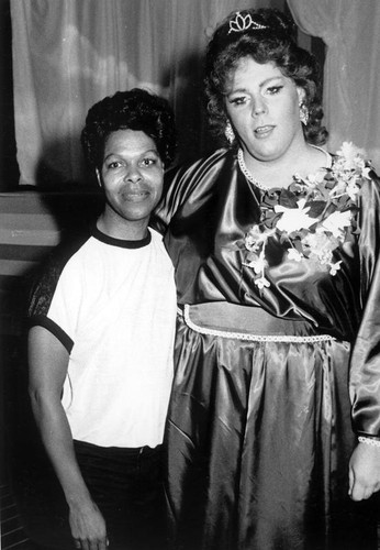 Two unidentified individuals, one dressed as a female impersonator