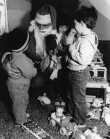 Dennis Andrews plays Santa for children at the Billy DeFrank Center