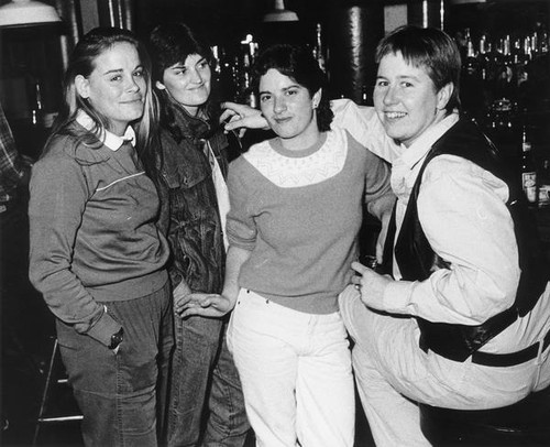 Group portrait of four women in a bar