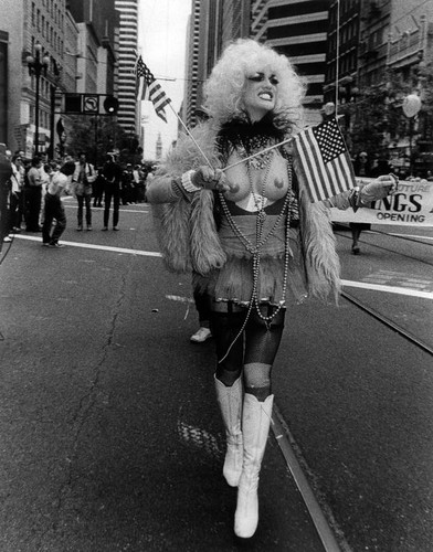 Female impersonator holding American flags