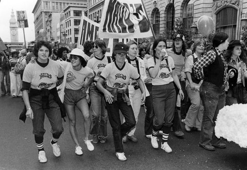 Parade participants wearing "Maud's, San Francisco" T-shirts