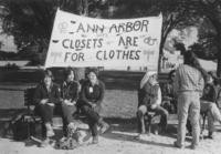 Women on park benches with banner