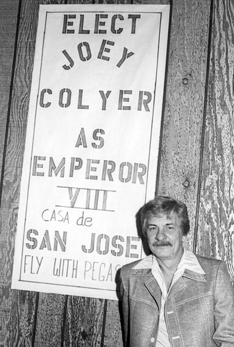 Joey Colyer next to his election banner