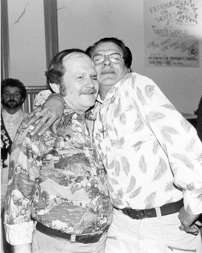 Two smiling men hugging