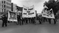 Three banners carried in march