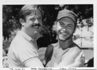 Two men posing at a Pride Celebration