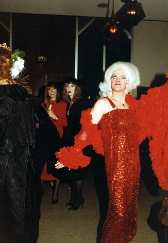 Female impersonator wearing a red sequined gown