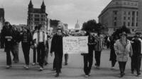 Marchers with Stonewall raid sign
