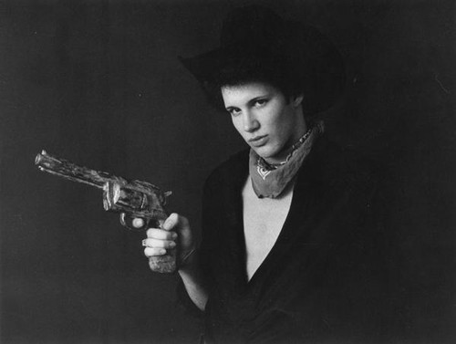 Man in western attire pointing gun