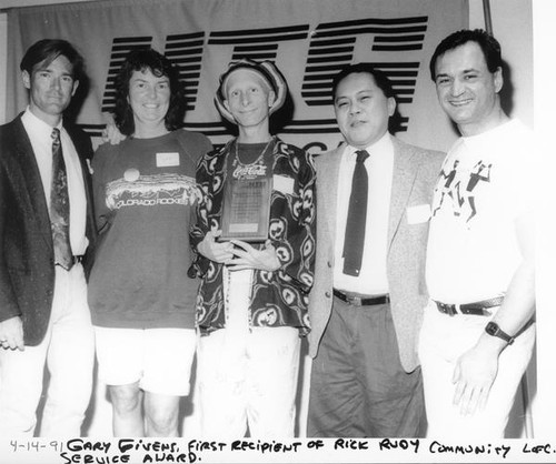 Gary Givens holding his award