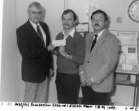 Man holding check donation